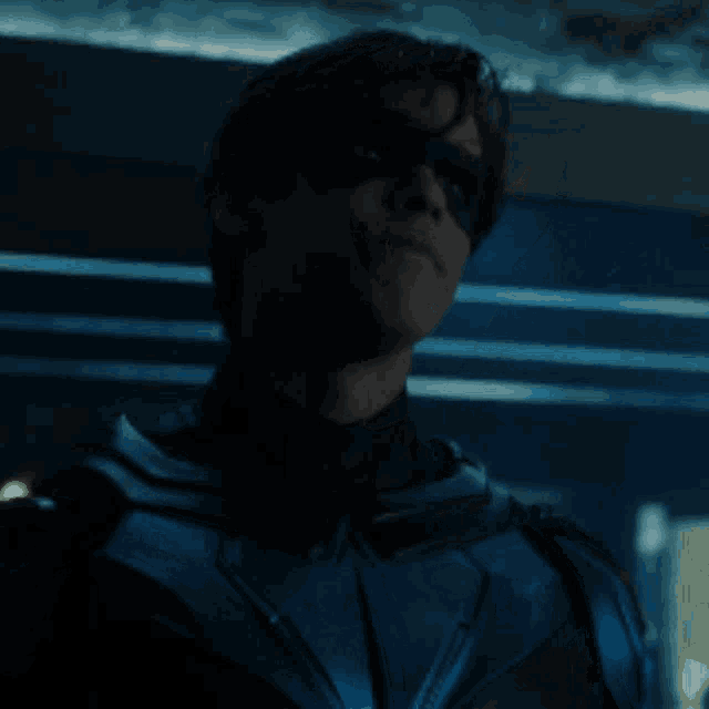 a man in a blue and black superhero costume