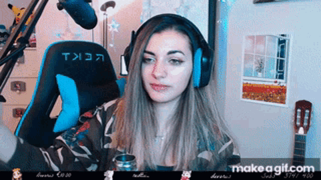 a woman wearing headphones sitting in front of a microphone