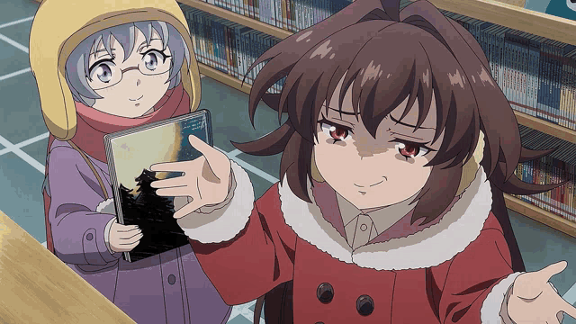 a girl in a red coat holds a book in her hand