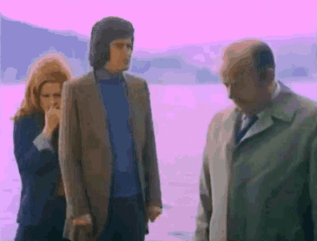 a man in a suit and tie is standing next to a woman