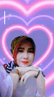 a woman wearing a scarf and a watch stands in front of a heart shaped background