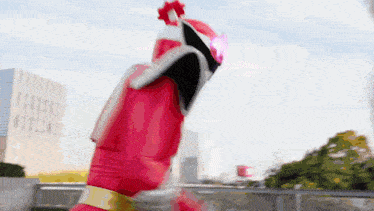 a person in a red superhero costume with a helmet on