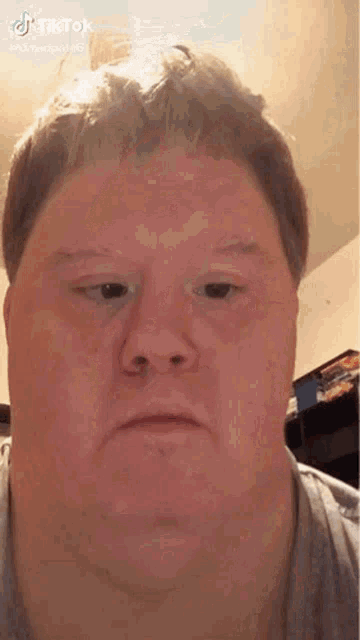 a close up of a man 's face with a very sad look on his face .