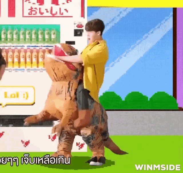 a man in a yellow jacket is riding a dinosaur costume .
