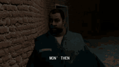 a man with a beard is standing next to a brick wall and says square-go like