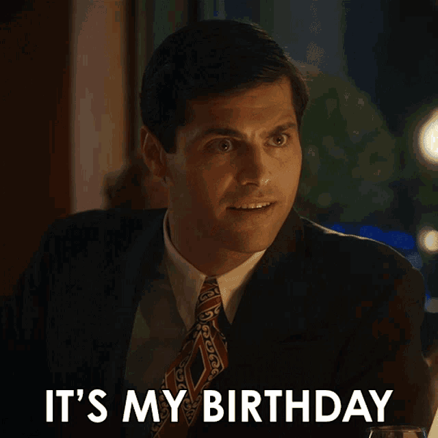 a man in a suit and tie with the words it 's my birthday above him
