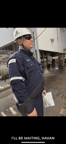 a man wearing a hard hat and sunglasses says i 'll be waiting