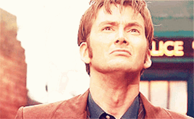 a man stands in front of a police box