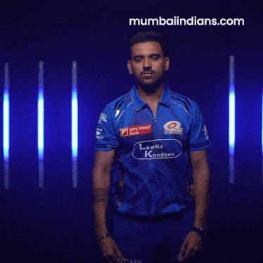 a man wearing a blue shirt that says indians on it