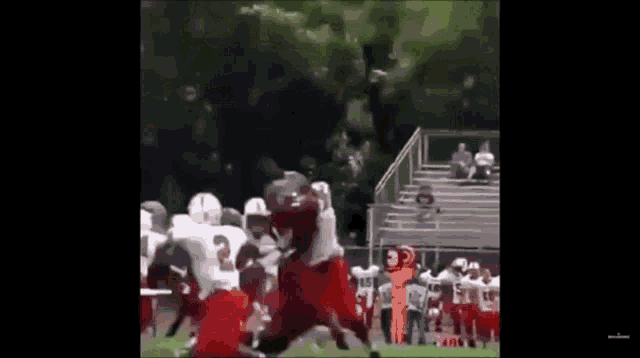 a group of football players are playing on a field and one of them has the number 3 on their jersey
