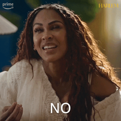 a woman in a white sweater says " no " in front of her face