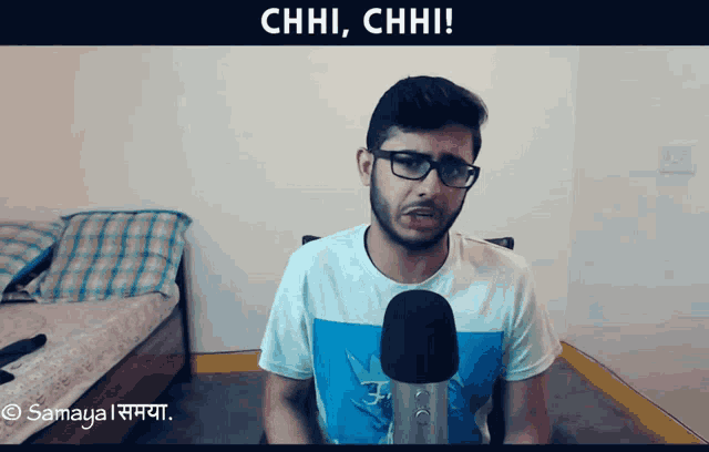 a man talking into a microphone with chhi chhi written on the bottom