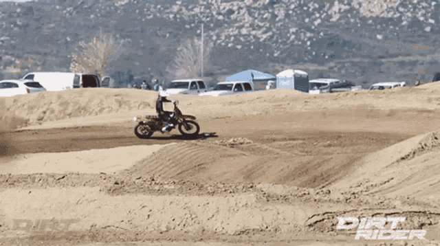 a dirt rider riding a dirt bike on a track