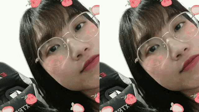 a girl wearing glasses has strawberries around her face
