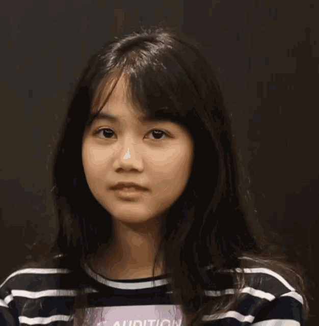 a girl wearing a striped shirt with the word audition on the front