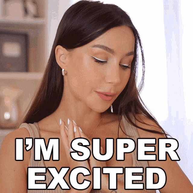 a woman says i 'm super excited while wearing white nails