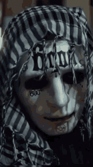 a person wearing a scarf and a mask that says ' blood '