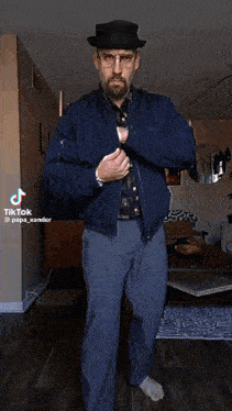 a man in a blue jacket and tie is standing in a living room with tiktok written on the bottom right corner