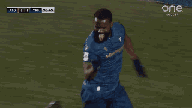 a soccer player wearing a blue jersey that says gree max