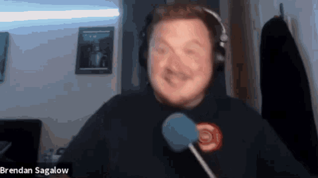 a man wearing headphones with the name brendan sagalow on the bottom right