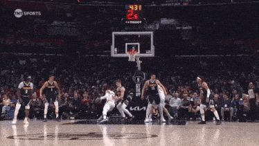 a basketball game is being played in front of a crowd and the score is 19 to 19