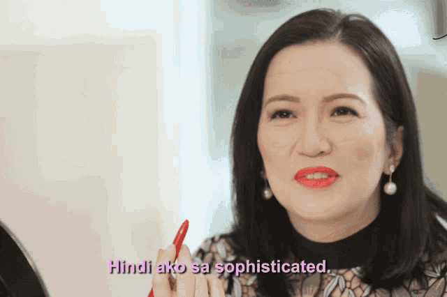 a woman holding a red pen with the words hindi ako sa sophisticated above her