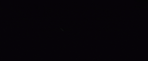 a dark background with a red light coming out of the middle