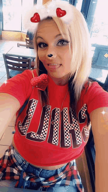 a woman wearing a red shirt that says lions