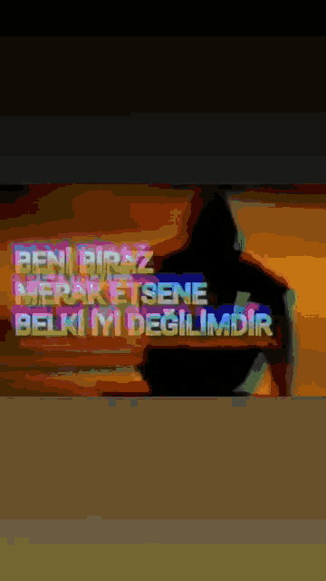 a blurry image of a person with the words beni biraz merak etsene belki iyi degilimdir