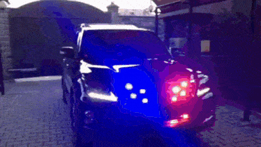 a black car with a blue light on the hood