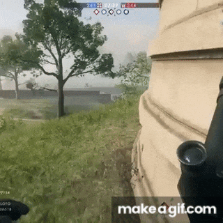 a person is holding a gun in a video game while standing next to a building .