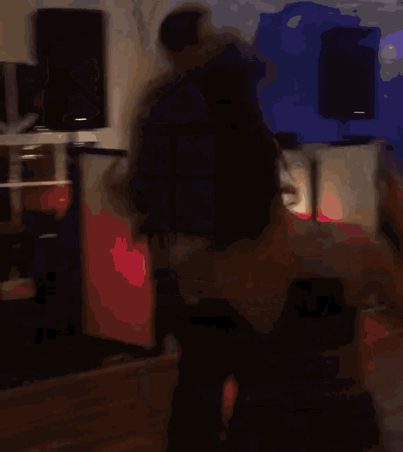 a blurred image of a person dancing in front of a coca cola machine