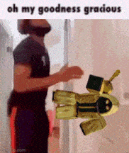 a man is standing next to a yellow robot that says oh my goodness gracious on it .