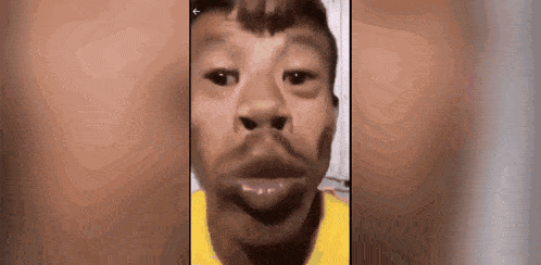 a close up of a man 's face with a beard on a cell phone .