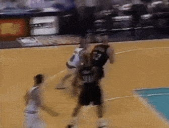 a basketball player wearing a number 22 jersey tries to block another player