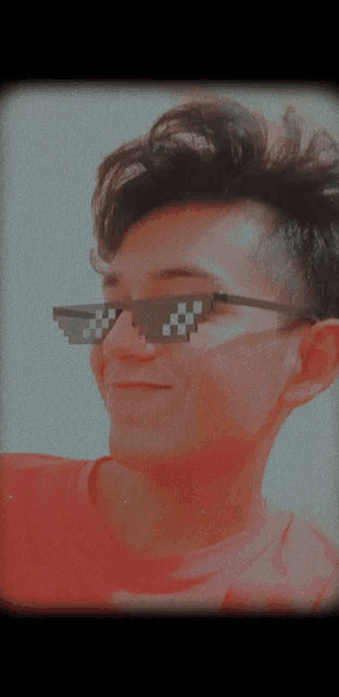a man wearing a red shirt and a pair of sunglasses with a smiley face on it