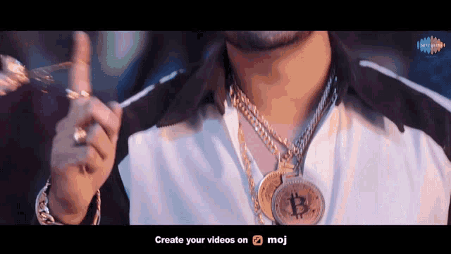 a man is wearing a necklace with a bitcoin pendant around his neck