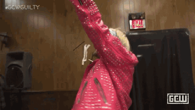 a person wearing a pink jacket with the word guilty on the bottom