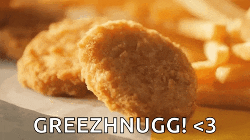 a close up of a chicken nugget next to french fries with the words greezhnugg below it