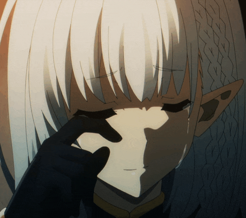 a close up of a girl with white hair covering her face with her hand