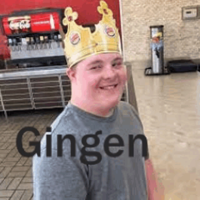 a young man wearing a crown is smiling in a burger king restaurant .