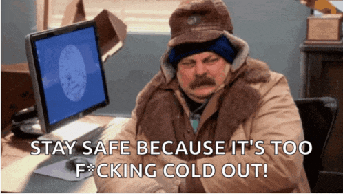 a man is sitting in front of a computer with the words " stay safe because it 's too f * cking cold out "