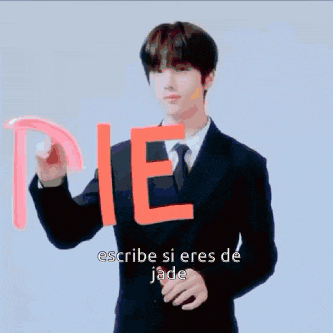 a man in a suit and tie is holding the word die in his hand