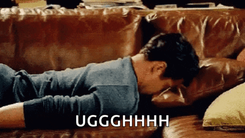 a man is laying on a couch with his head on a pillow and the words uggghhhh written on the bottom