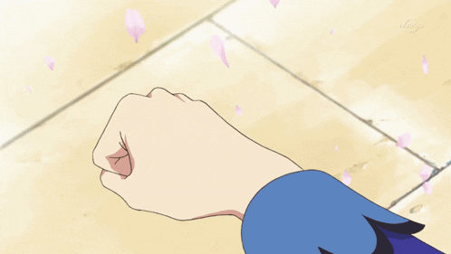 a girl with blonde hair and a blue bow on her head waves her hand
