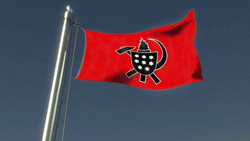 a red flag with a black symbol on it is flying in the wind