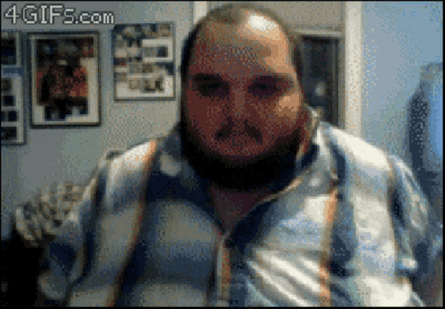 a man with a beard is looking at the camera with a 4gifs.com watermark in the corner
