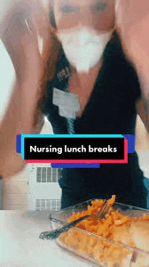 a nurse wearing a mask is eating a casserole dish of food .