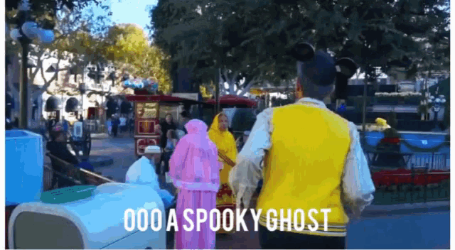 a man in a yellow vest says " 000 a spooky ghost " in front of a crowd