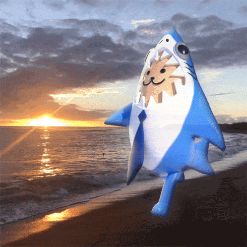 an inflatable shark with a sun in its mouth is standing on a beach